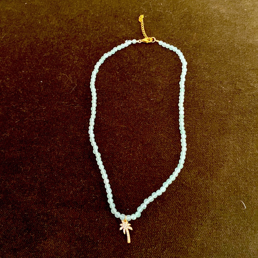 Beautiful crystal necklace with palm at center